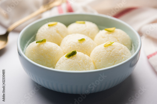 Indian Rasgulla or Rosogulla dessert/sweet served in a bowl. selective focus photo