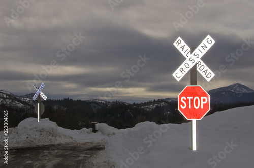 Railroad Crossing and Stop Sign in snow bank on small county road, Southern Oregon  photo