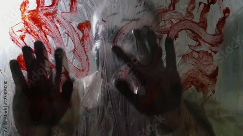 The zombie smears blood on the glass in the dark room,slow motion.