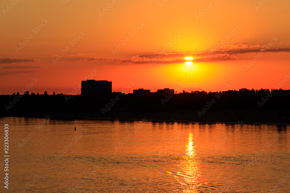 Naklejka premium Orange sunset over a river Dnieper in Kremenchug city, Ukraine