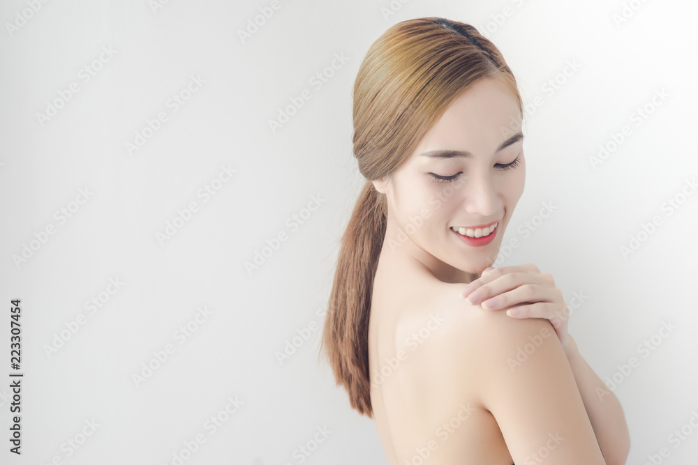 Pretty girl with nude make up and naked shoulders posing at background, beauty photo concept, skin care Pretty girl with nude make up and naked shoulders posing at background, beauty photo concept, skin care