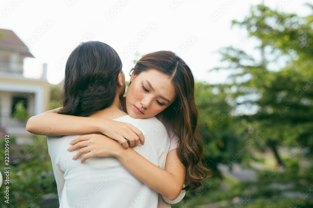 Portrait two women. Sad unhappy young woman being consoled by her friend. Friendship help support and difficult times concept. Human emotions feelings Portrait two women. Sad unhappy young woman being consoled by her friend. Friendship help support and difficult times concept. Human emotions feelings