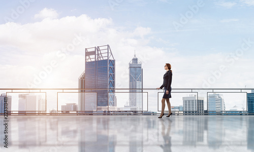 Sunrise above skyscrapers and businesswoman facing new day © adam121