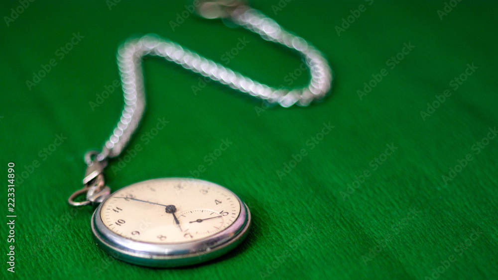Pocket Watch with chain on green background Pocket Watch with chain on green background