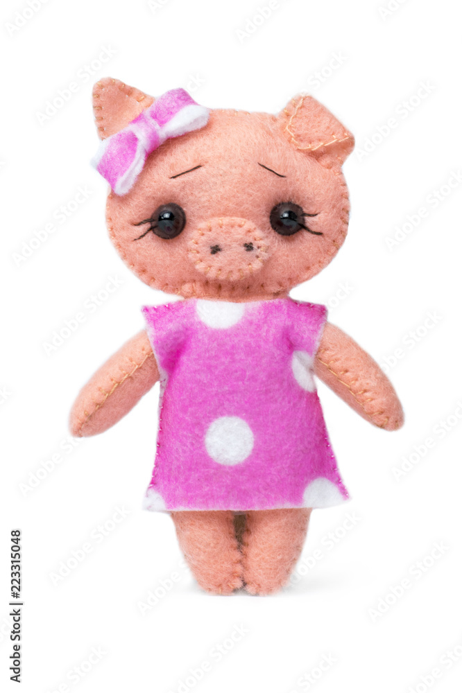 .Handmade toy pig in dress on white isolated background. .Handmade toy pig in dress on white isolated background.