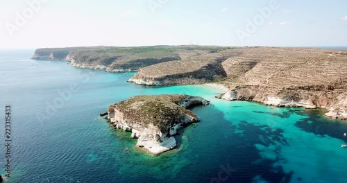 Aerial view of the island of Lampedusa, Sicily, Italy near Isola dei Conigli with Mediterranean sea. Italian natural landscape seen from the sky with drone flying over beaches