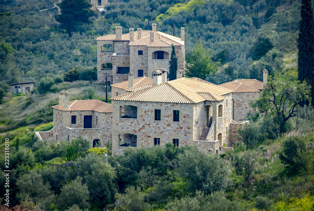 New built luxurious stone house with ceramic roofs surrounded by green nature. Greece