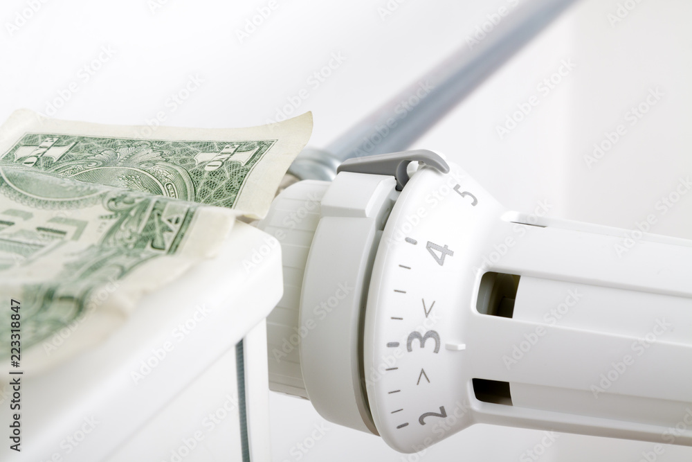 Radiator and one dollar. Money on heating battery. Heating season concept Radiator and one dollar. Money on heating battery. Heating season concept
