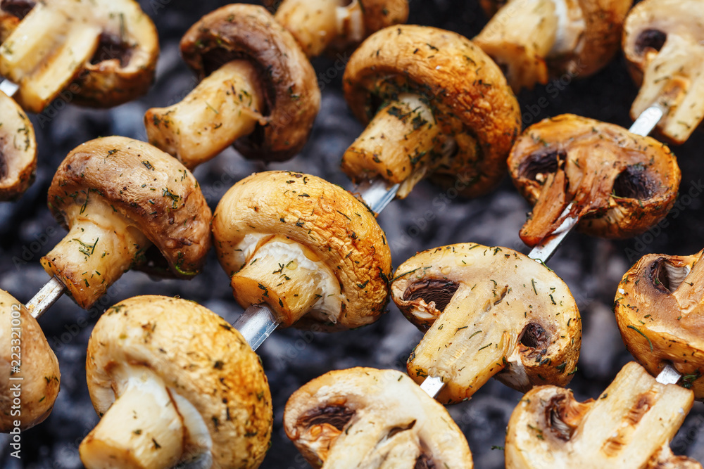 Barbecue skewers with grilled champignon mushroom kebab in a brazier Barbecue skewers with grilled champignon mushroom kebab in a brazier
