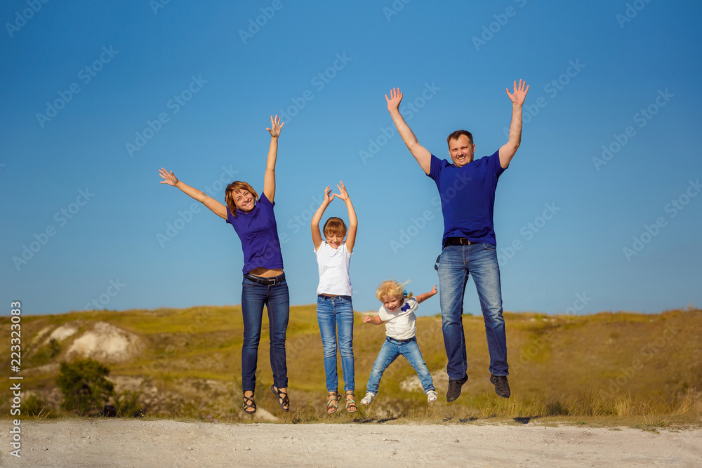 happy family is fooling around in nature and bouncing against a blue sky. happy family is fooling around in nature and bouncing against a blue sky.