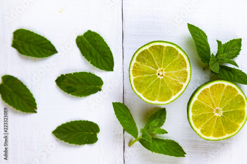 Lime and mint on a  wooden table.