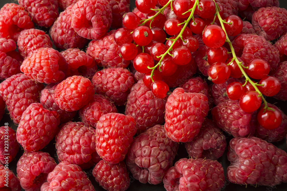 Background of raspberries and red currants. Fresh berries closeup. Top view. Background of red berries. Various fresh summer fruits. Background of raspberries and red currants. Fresh berries closeup. Top view. Background of red berries. Various fresh summer fruits.