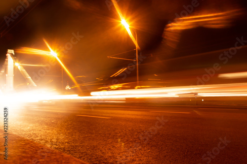 light from the headlights of cars in motion