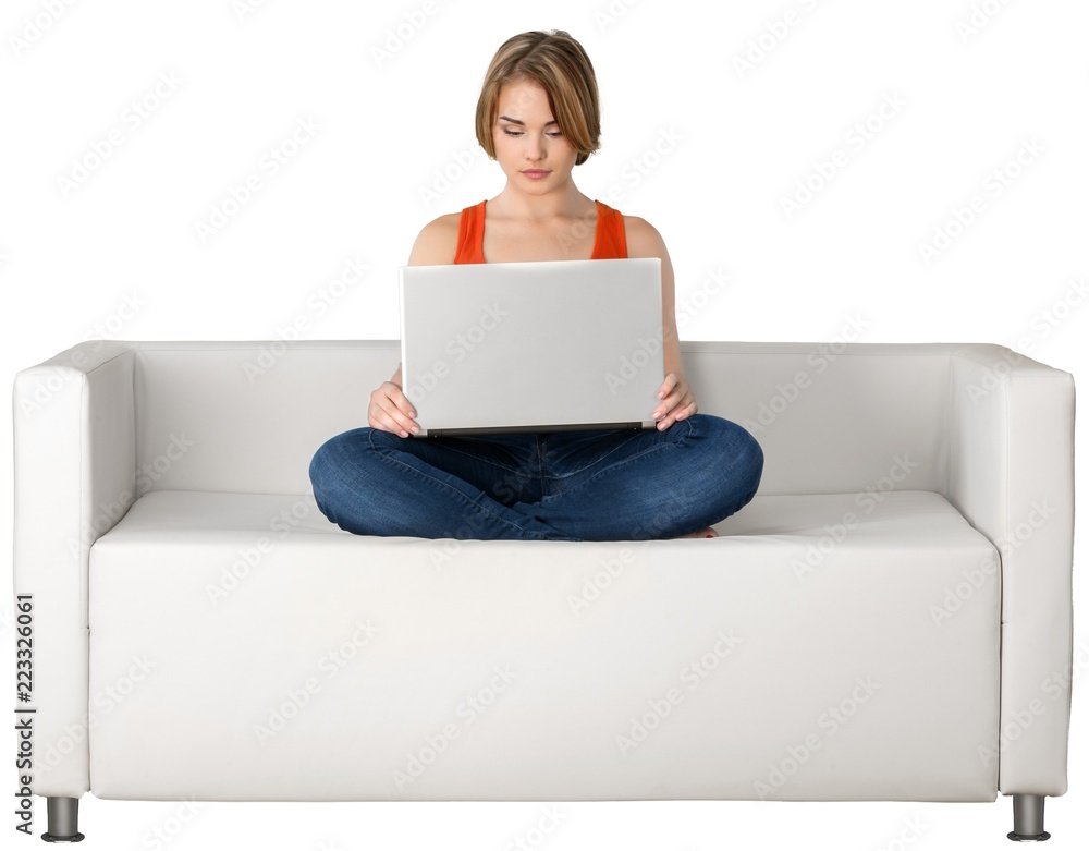 Portrait of a Woman Using her Laptop on a Couch Portrait of a Woman Using her Laptop on a Couch