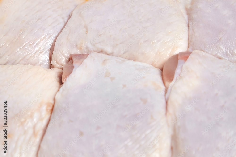 Raw chicken thighs with skin. Meat of poultry background Raw chicken thighs with skin. Meat of poultry background