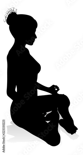 A silhouette of a woman in a yoga or pilates pose 
