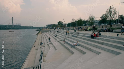 People walking along the boulevard over the Wis?a in Warsaw. Summer 2018 photo