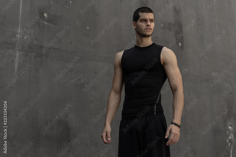 Sport model man posing gray wall background Sport model man posing gray wall background