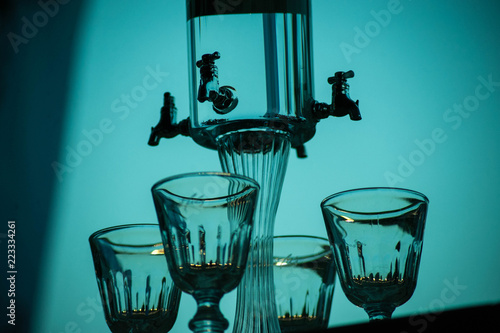 Classic ritual of glass of absinthe and dripping fountain. photo