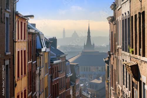 Beautiful urban cityscape see through with a view over Liege  Belgium  from one of the street leading up the hill on a sunny winter morning