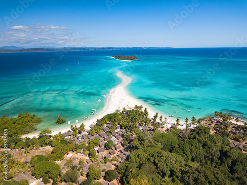 Fototapeta Naklejka Na Ścianę i Meble -  Aerial view of a magnificent landscape: an island with white beach, crystal clear sea, palm trees. Wonderful places for a dream vacation. Concept of: holiday, wild, nature.