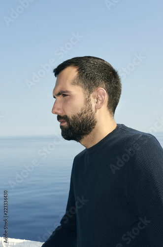 Handsome man on the deck of a ship during holiday.