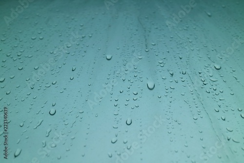 Rain drops on the window in rainy day. Selective focus. Background concept.