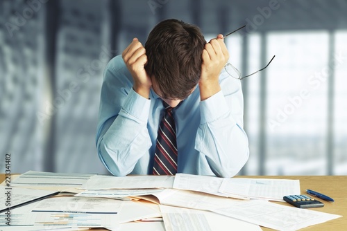 Young business man in suit tired from
