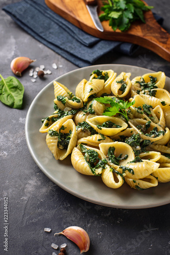 Conchiglioni pasta with spinach in creamy sauce 