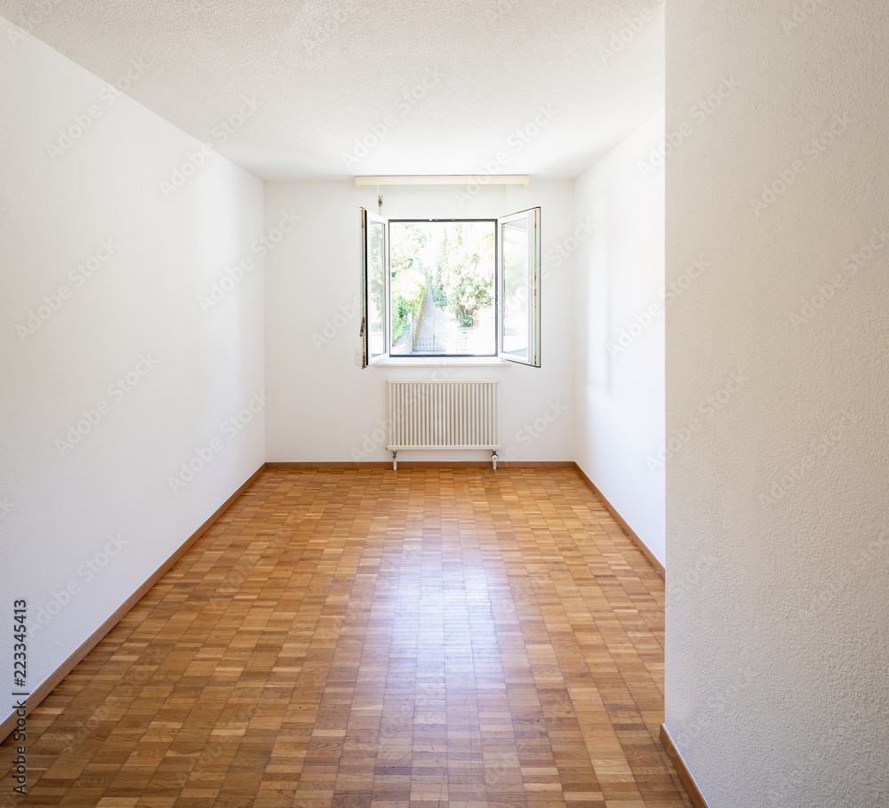 Empty room with window and parquet Empty room with window and parquet