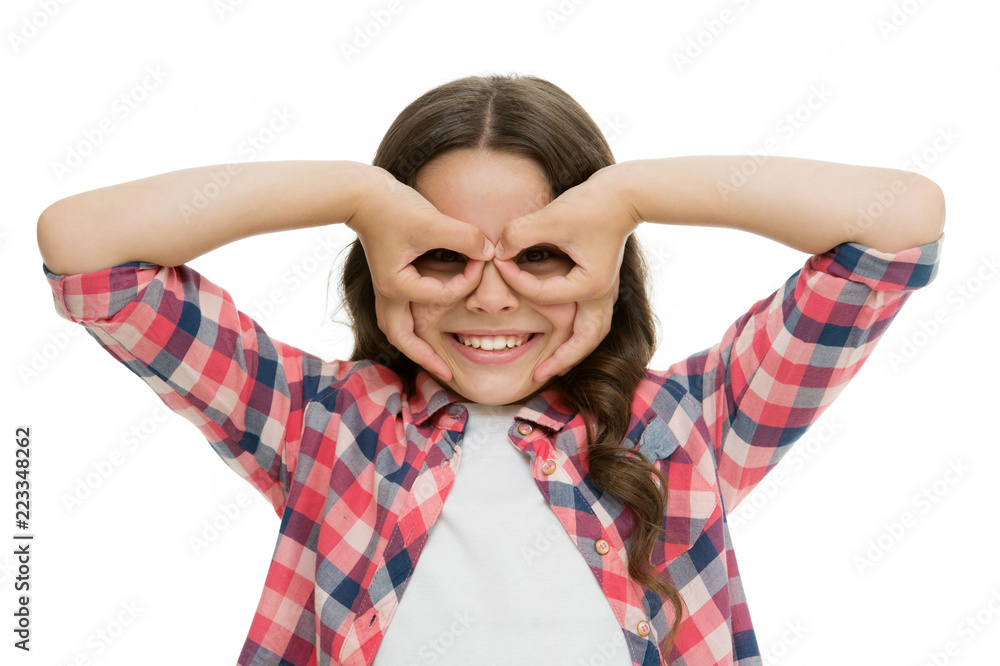 Girl holding fingers near eyes like glasses mask superhero or owl. Play  game with mask superhero.