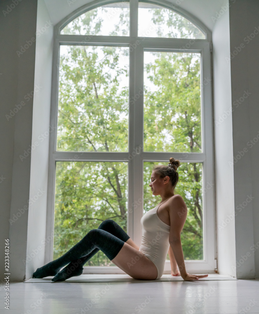 Beautiful young girl dancing in the Studio by the window and mirror Beautiful young girl dancing in the Studio by the window and mirror