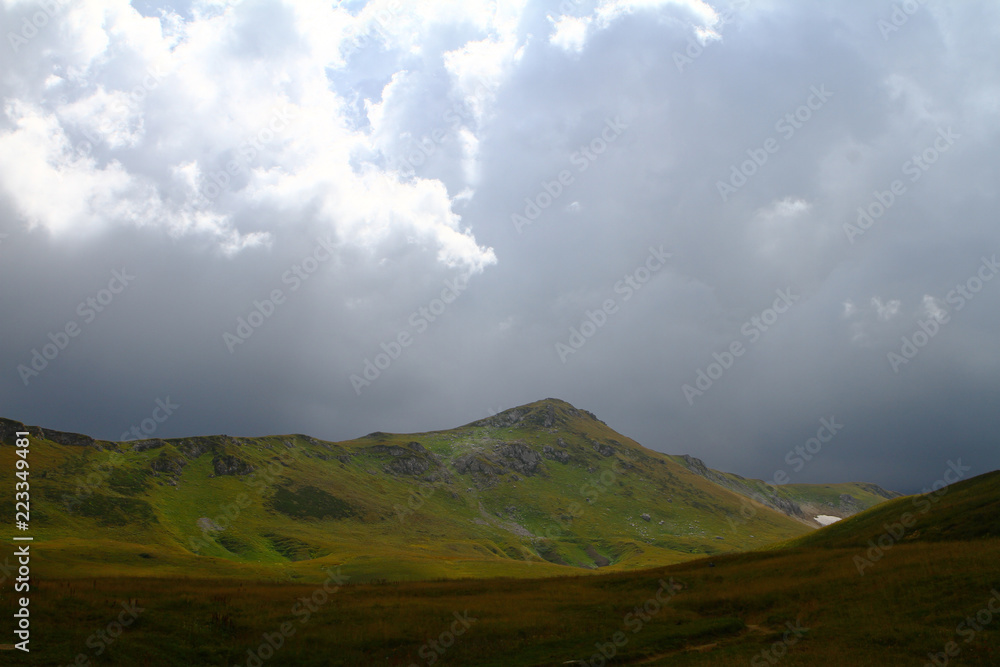 natural landscape photo of northern mountain landscape with heavy grey cloudy sky