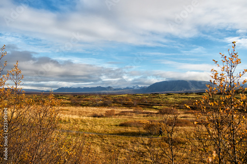 iceland plain landscape view with field in reykjavik. autumn landscape of plain thingvellir. weather and climate. nature and ecology. nature places to stop. sense of freedom. iceland mountains.
