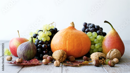 Still life of autumn fruits and vegetables. White wooden background

