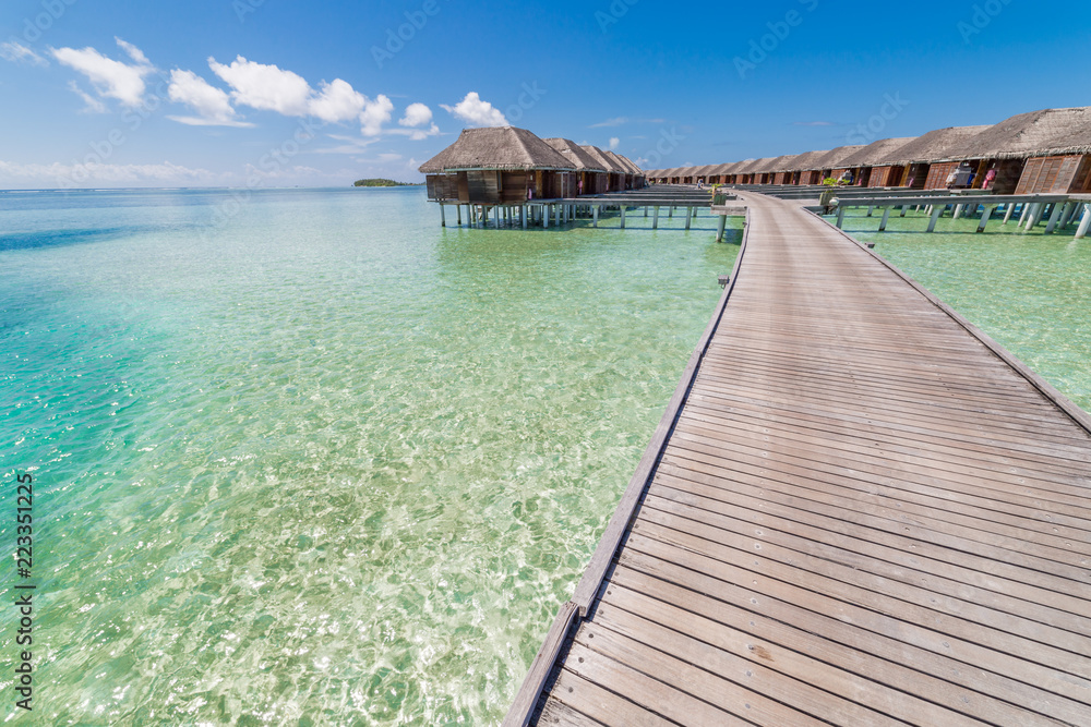 Beautiful beach with water bungalows at Maldives. Perfect beach panorama for summer travel destination banner background
