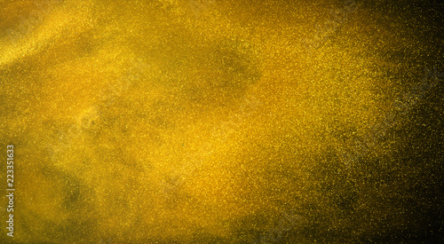 Gold glitter texture on black background. photo