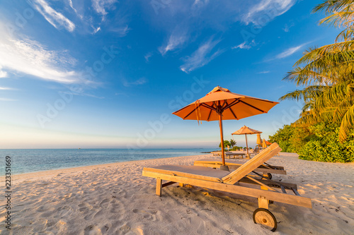 Beautiful Maldives island beach landscape. Chairs and umbrella for summer vacation and holiday background. Exotic tropical beach concept