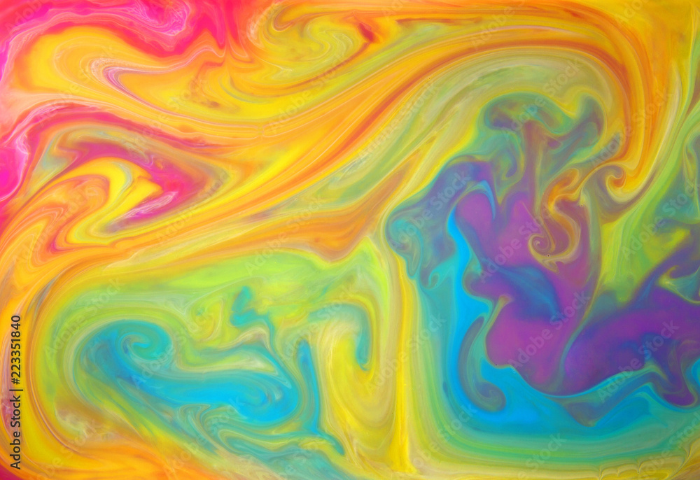 Obraz premium Colored liquids mixed together in fluid creating colorful abstract background