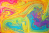Colored liquids mixed together in fluid creating colorful abstract background
