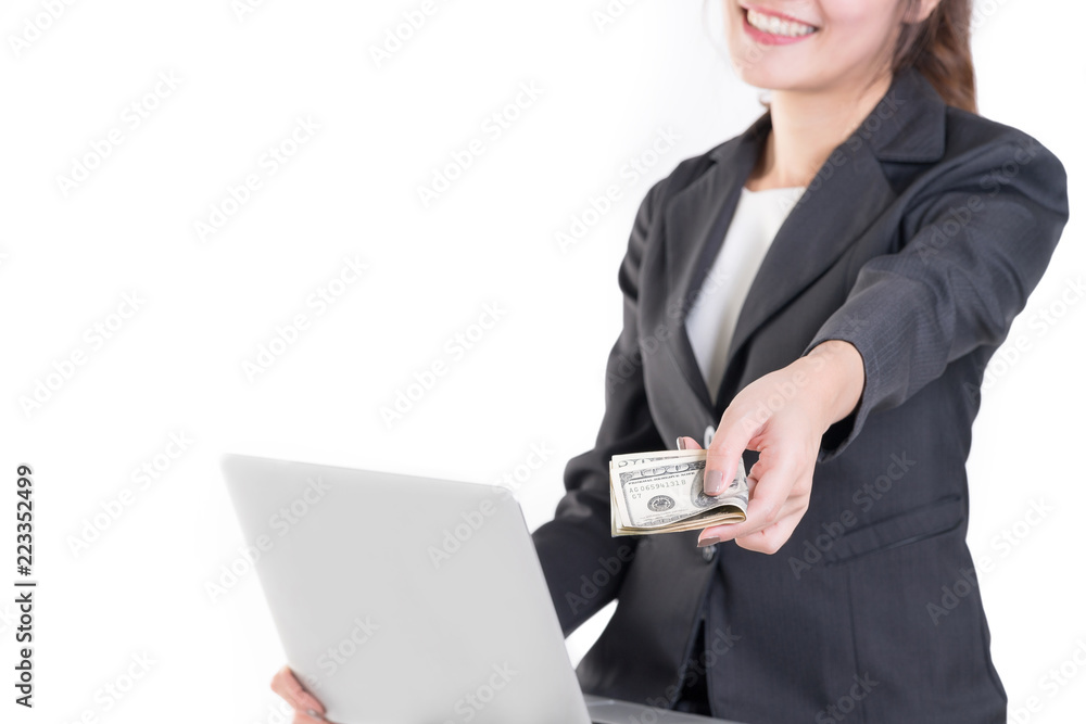 Businesswoman sitting on a wooden high chair and works on the laptop with money in hand. Isolated on white. Businesswoman sitting on a wooden high chair and works on the laptop with money in hand. Isolated on white.