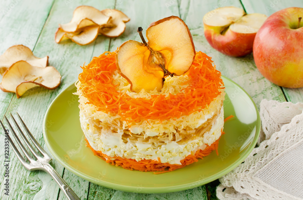 Layered salad with carrots, egg, cheese and apple Layered salad with carrots, egg, cheese and apple