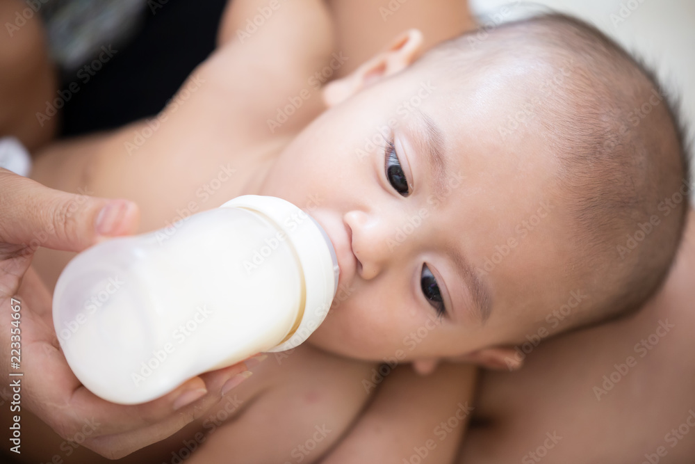 Close-Up Portrait Of Cute Baby Boy Lying On Bed, Asian baby in the room Close-Up Portrait Of Cute Baby Boy Lying On Bed, Asian baby in the room