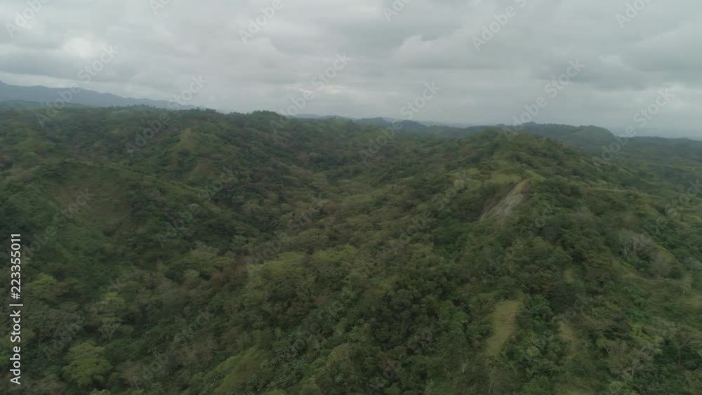 Aerial view of mountains covered forest, trees. Cordillera region. Luzon, Philippines. Mountain landscape in cloudy weather. Aerial view of mountains covered forest, trees. Cordillera region. Luzon, Philippines. Mountain landscape in cloudy weather.