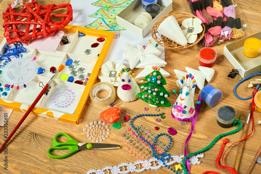 Fototapeta premium Handmade decorations for new year and other holidays. Artwork workplace with creative accessories.