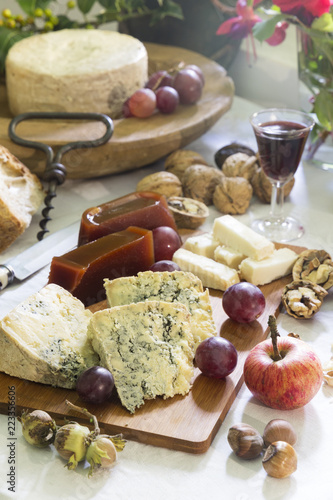 Rustic Still-life of Asturian blue cheese (cabrales) with sweet quince, nuts, hazelnuts, grapes, apple, and red wine