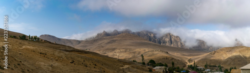 Evening panoramic view of Mount Talysh. Mountain village. Amazing dawn sky over the misty mountains. Azerbaijan, Yardymli.
