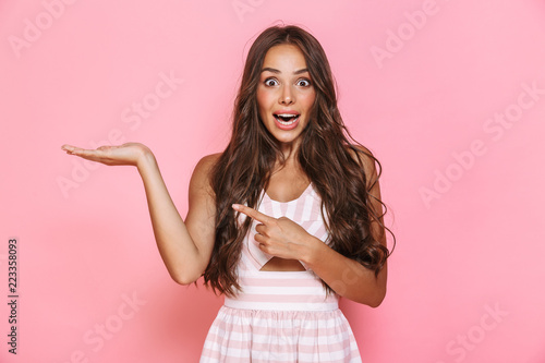 Obraz na plátně Image of caucasian woman 20s with long hair wearing dress smiling and holding co