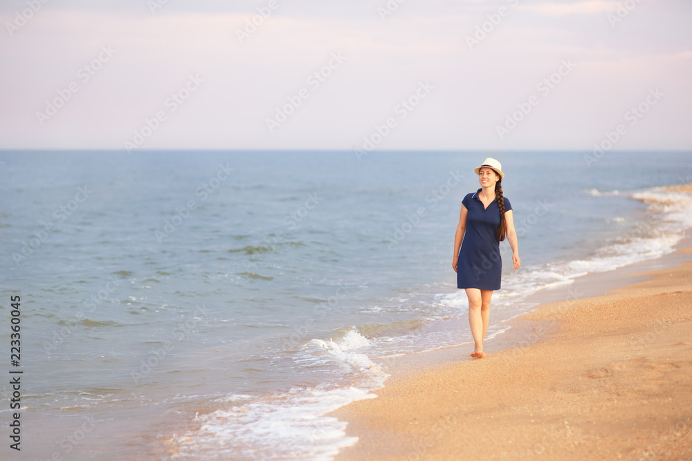 woman walking on the sea beach