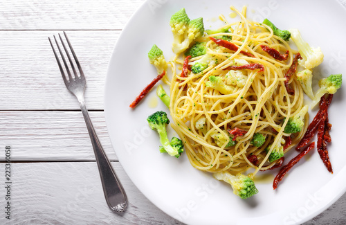 Pasta. Spaghetti with broccoli, cauliflower and dried tomatoes